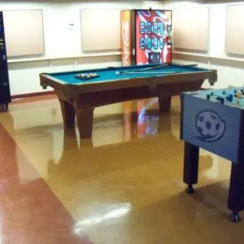 A games room with a foosball table and a pool table