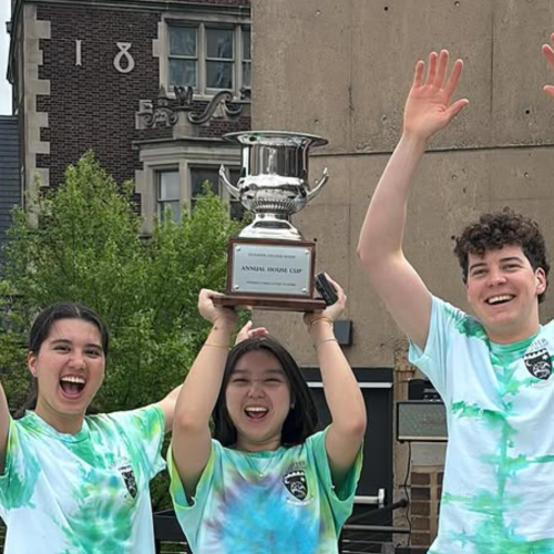 Stouffer residents hold the Stouffer College House Cup trophy aloft