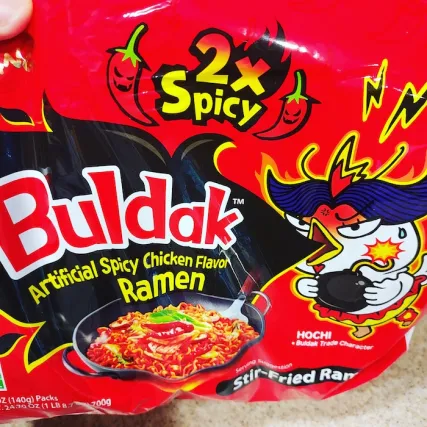 Image of 2x Spicy Buldak Ramen with a cartoon chicken and fire emitting from its beak