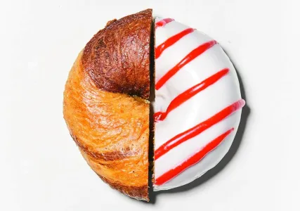 A donut and bagel cut in half facing each other.