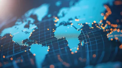 A stylized image of a world atlas with lights indicating major population centers