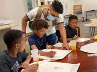 children learning - teacher standing over students