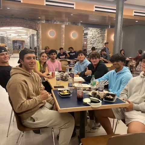 Fisher Hassenfeld residents eat together in a dining hall
