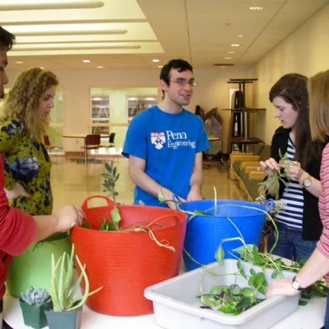 Members of KCECH's Garden Club re-pot plants