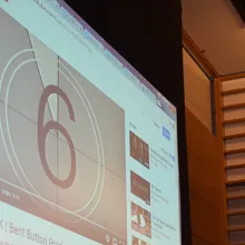 A film countdown plays on a large auditorium screen at a College House Film Festival screening.