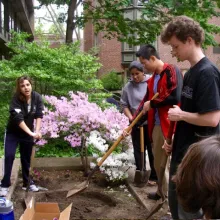 Members of KCECH's Biosphere program dig a pond for their courtyard