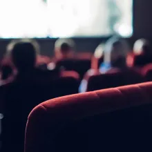 People watching a movie in a theatre, in soft focus