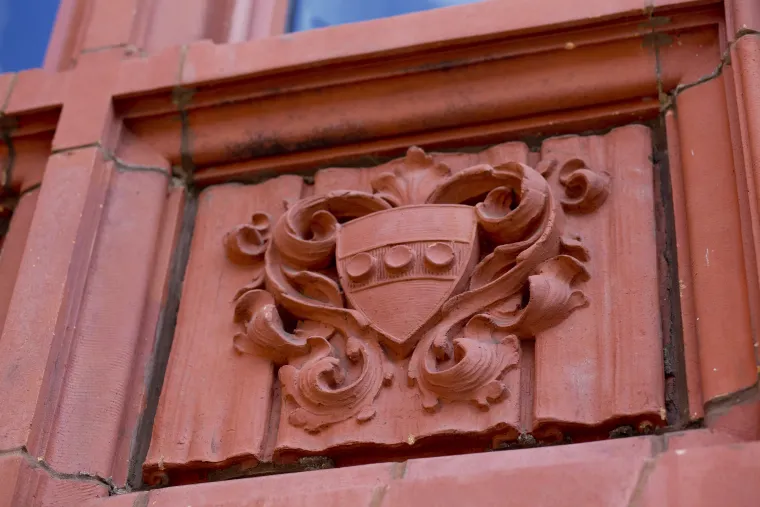 The University of Pennsylvania crest sculpted on a terracotta panel on a Penn building