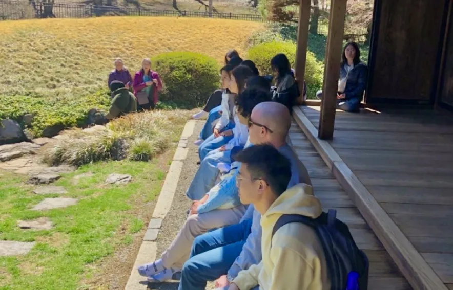 Lauder residents sit on the porch of a structure on a field trip