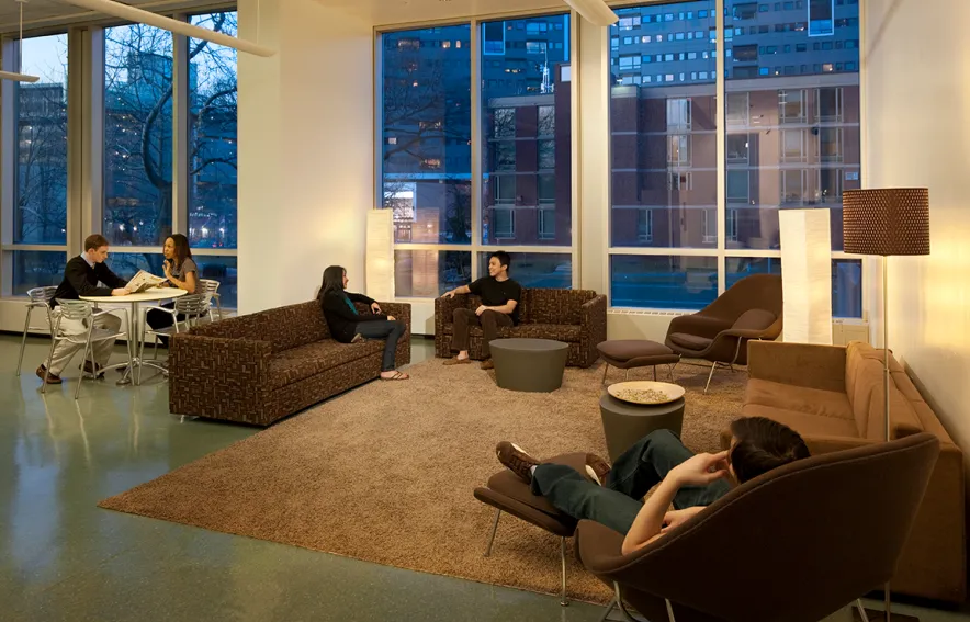 The Rodin Mezzanine at evening with couches and lounge chairs