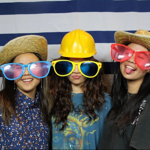 Three women at Hill's Pajama Jam, wearing comically large sunglasses and hats