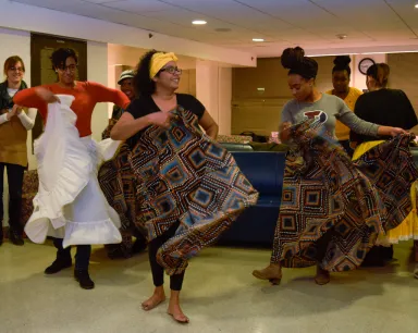Two Du Bois residents learn a dance presented by a dancer from an Afro-Caribbean instructor