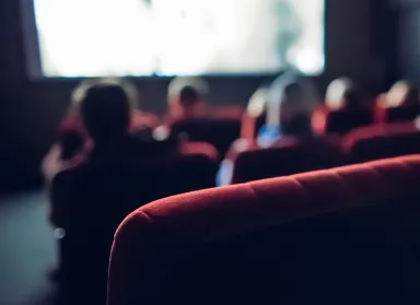 People watching a movie in a theatre, in soft focus