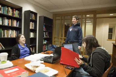 Students discussing classwork at a table