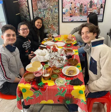 Members of the Latin American Residential Program eat Mexican food in the Italian Market